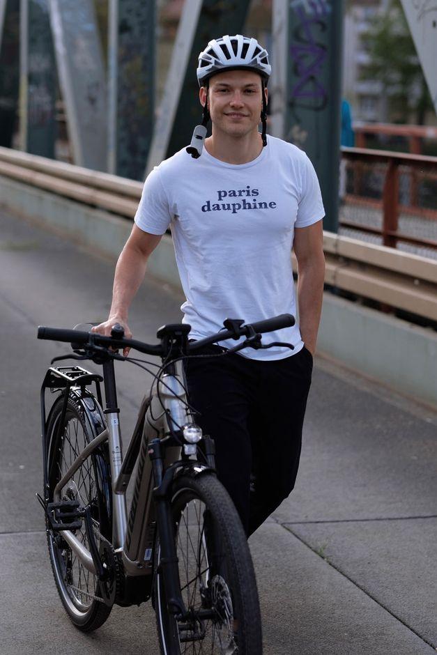 Man pushing a bicycle alongside him