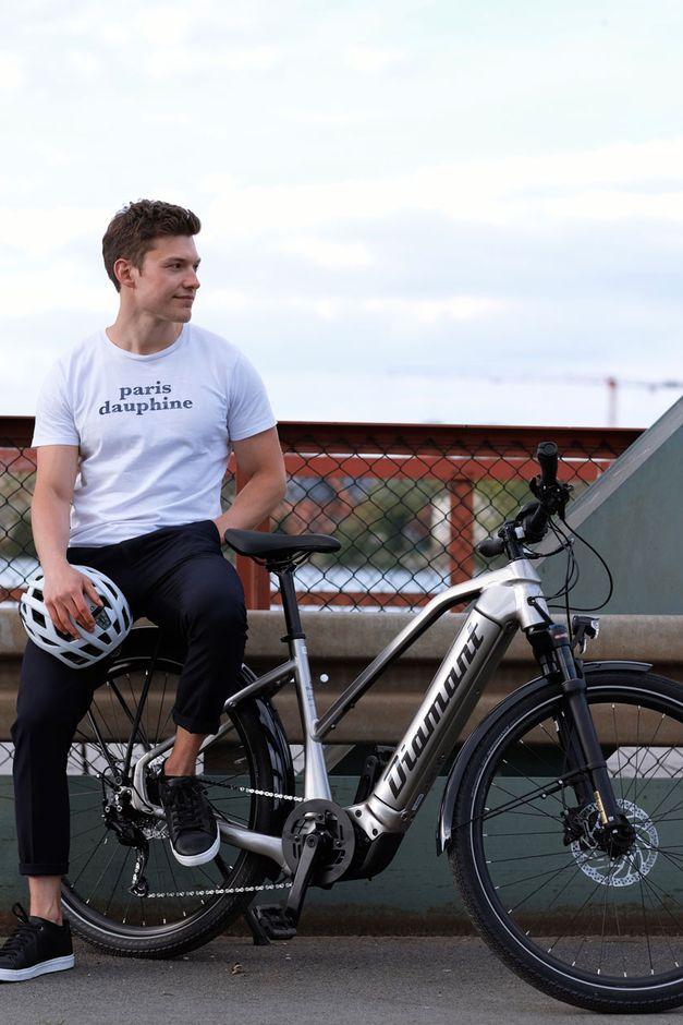 man sitting next to his bike