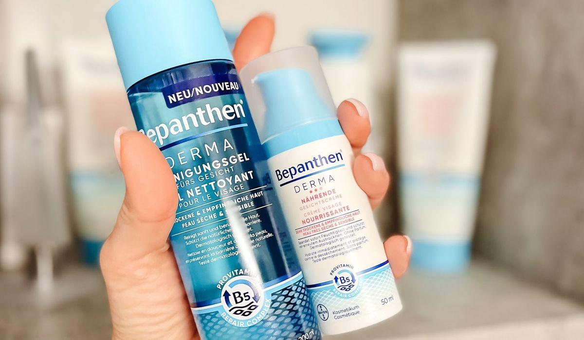 Hand holding two skin care products in front of the camera