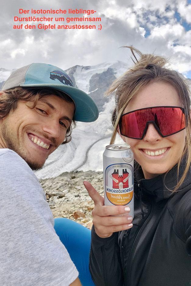 two happy people with beer in the mountains