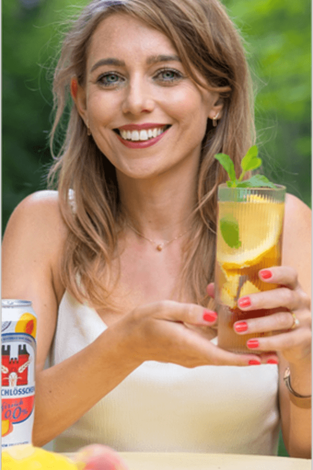 woman holding peach drink