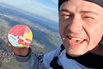 skydiver holding a yoghurt