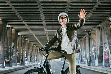 Man riding his bike and waving