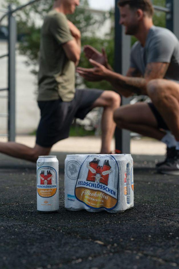 men doing sports with beer in the front